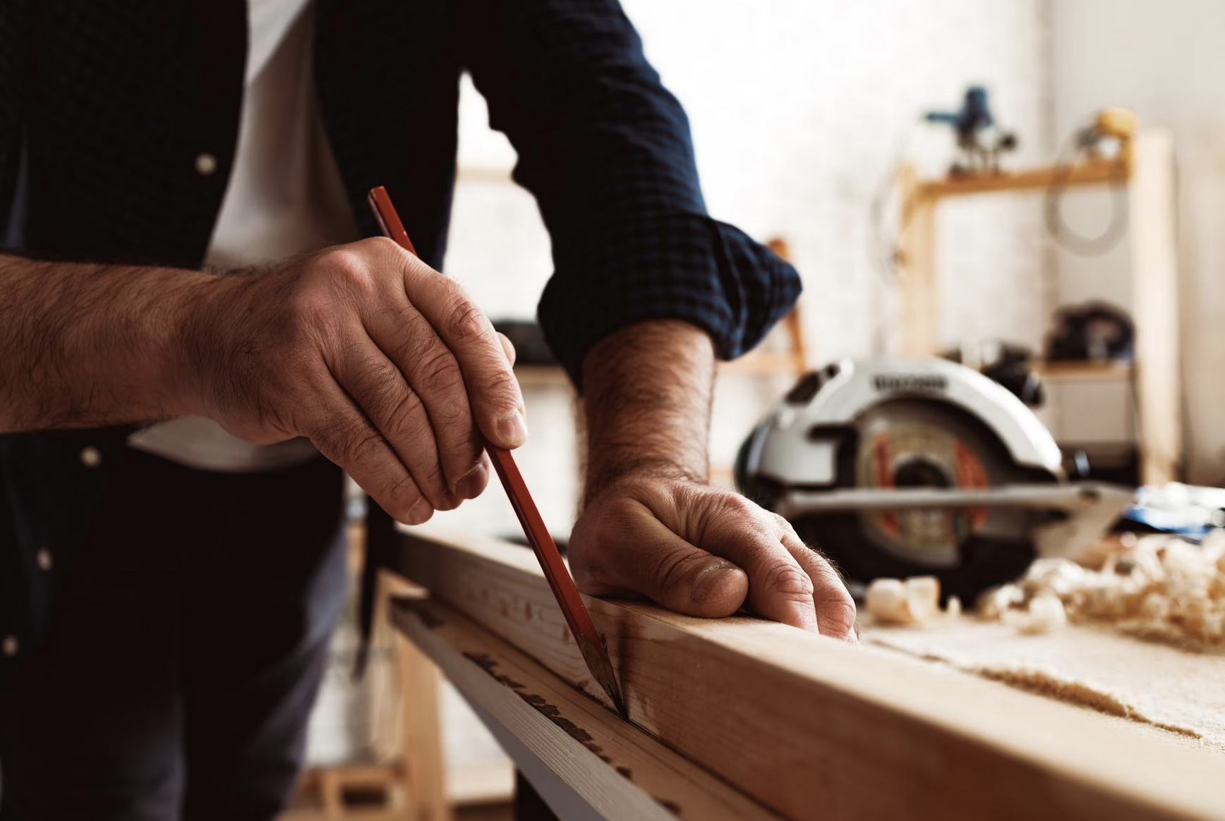 Carpenter making marks on a piece of wood